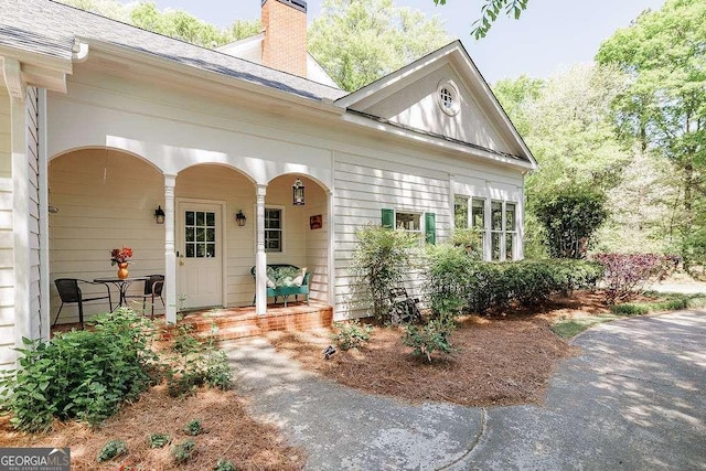 835 Timothy Rd, Athens, GA 30606 - view of front facade with a porch, a chimney, and roof with shingles