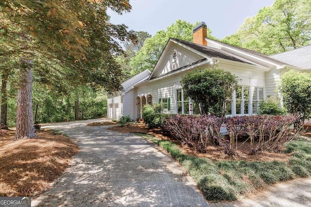 835 Timothy Rd, Athens, GA 30606 - view of side of home featuring an attached garage, a chimney, and aphalt driveway
