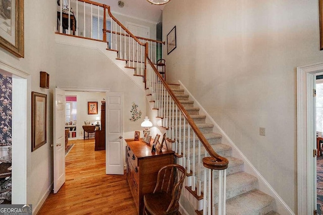 835 Timothy Rd, Athens, GA 30606 - staircase featuring wood finished floors, a towering ceiling, and baseboards