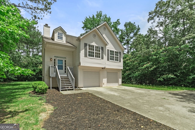view of front of house featuring a garage, a chimney, and concrete driveway