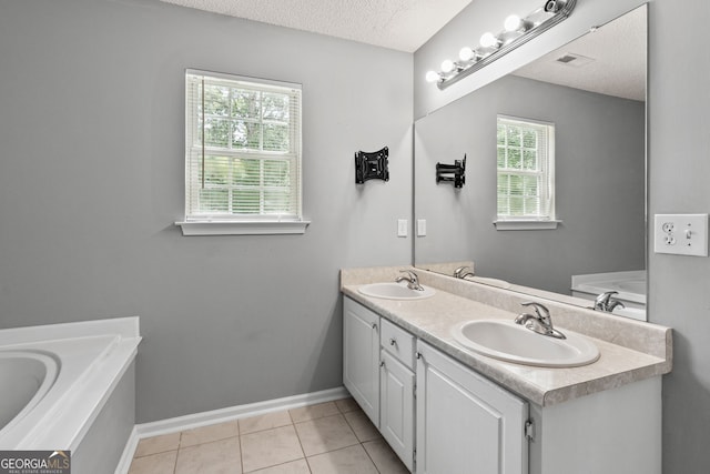 full bathroom featuring visible vents, double vanity, a textured ceiling, and a sink