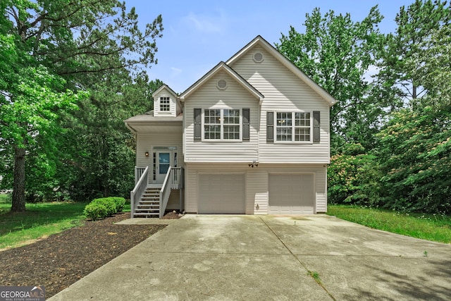 split foyer home with concrete driveway and a garage