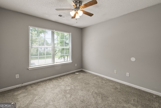 spare room with visible vents, a ceiling fan, baseboards, a textured ceiling, and carpet flooring