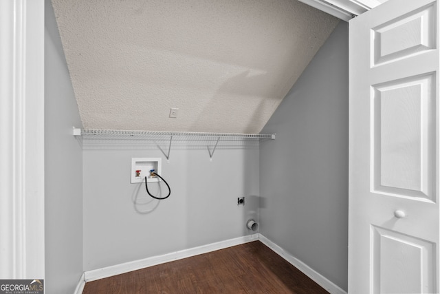 laundry room featuring hookup for a washing machine, a textured ceiling, dark wood finished floors, baseboards, and laundry area