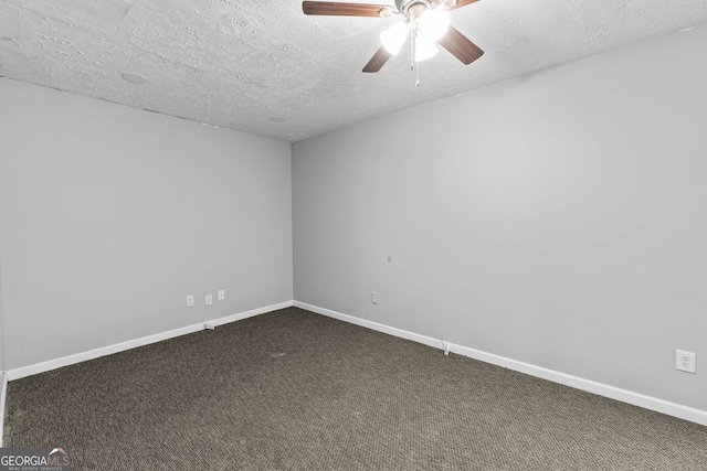 empty room featuring dark colored carpet, a textured ceiling, baseboards, and ceiling fan