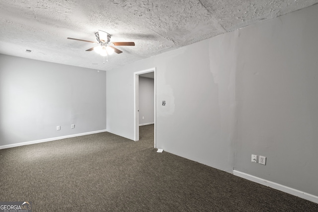 spare room featuring dark colored carpet, baseboards, a textured ceiling, and ceiling fan