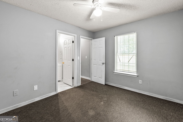 unfurnished bedroom featuring baseboards, carpet flooring, a textured ceiling, and connected bathroom