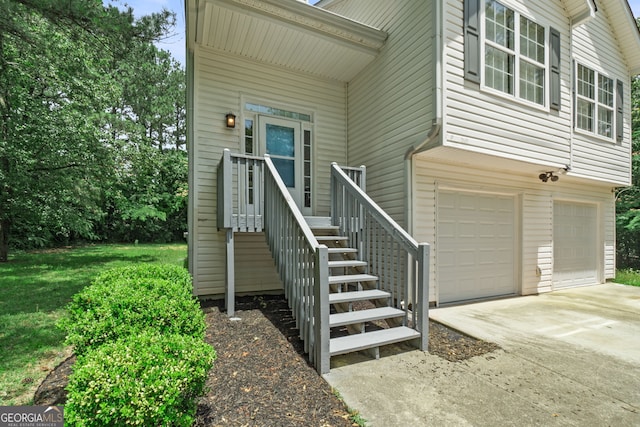 property entrance with driveway and a garage