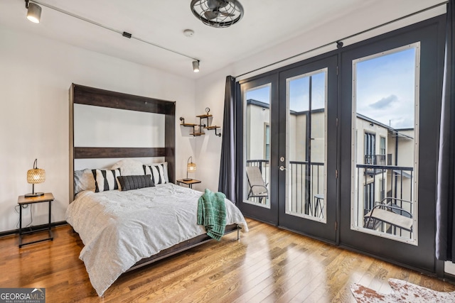 5300 Peachtree Rd Unit 3601, Atlanta, GA 30341 - bedroom with french doors, access to exterior, wood finished floors, and track lighting