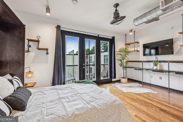 5300 Peachtree Rd Unit 3601, Atlanta, GA 30341 - bedroom with french doors, access to exterior, and wood finished floors