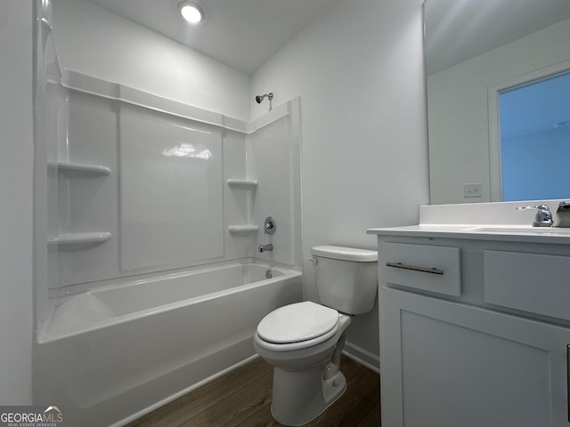 full bath with toilet, wood finished floors, bathing tub / shower combination, baseboards, and vanity