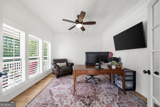 home office featuring wood finished floors, ceiling fan, and ornamental molding