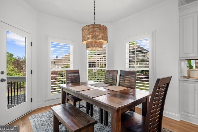 dining area with a healthy amount of sunlight, a chandelier, and light wood finished floors