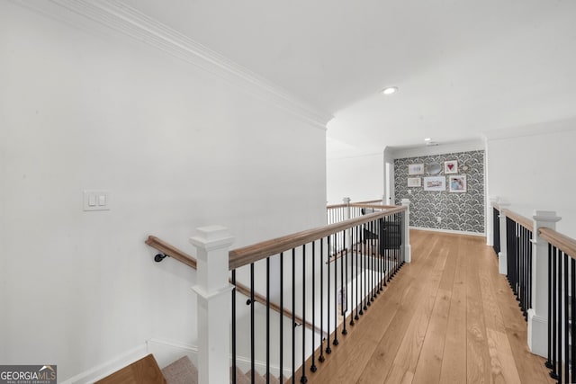 staircase featuring recessed lighting, hardwood / wood-style floors, baseboards, and ornamental molding