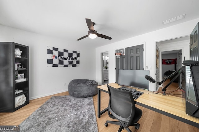 office area featuring wood finished floors, visible vents, and a ceiling fan