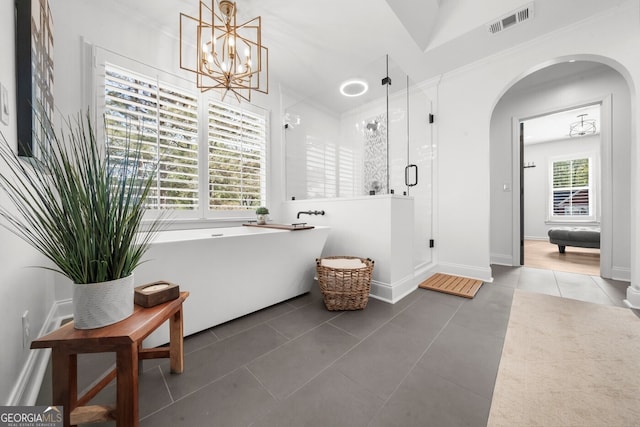full bathroom with a shower stall, tile patterned floors, visible vents, a soaking tub, and a notable chandelier
