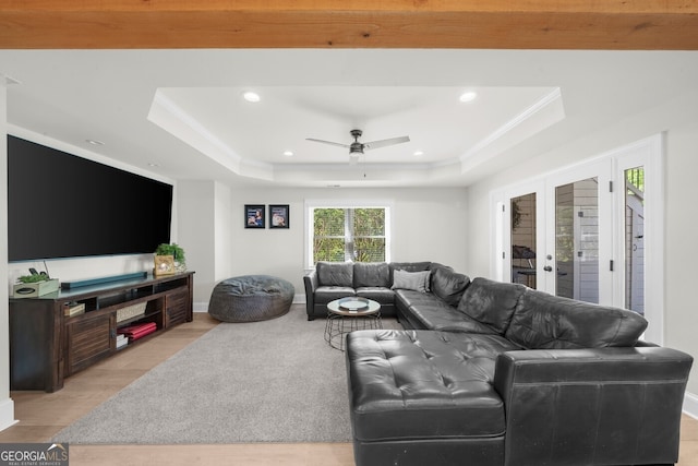 living area featuring recessed lighting, a raised ceiling, a ceiling fan, and light wood finished floors