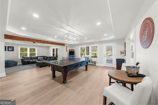 rec room featuring baseboards, light wood-style flooring, a tray ceiling, and recessed lighting