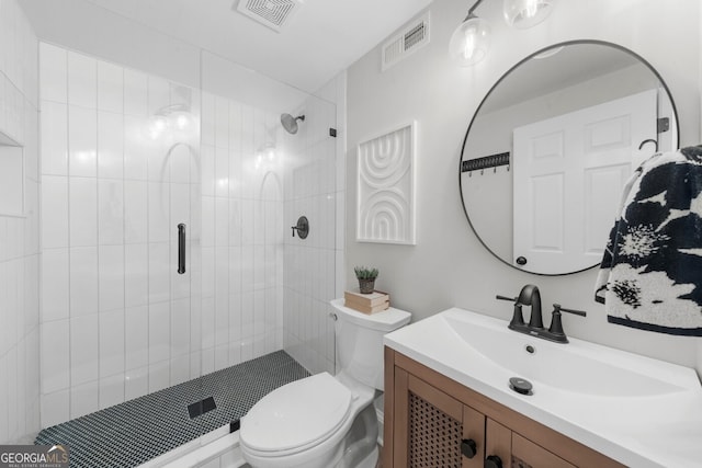 bathroom with vanity, visible vents, a shower stall, and toilet