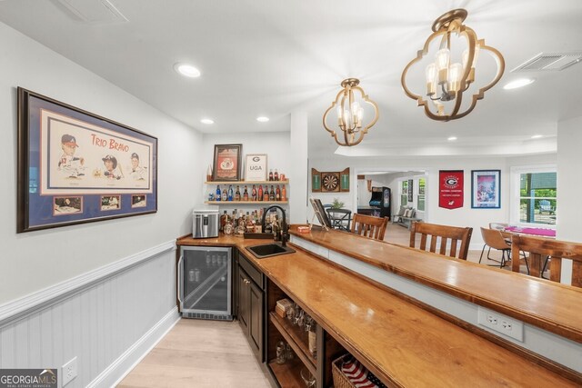 7390 Canter Run, Cumming, GA 30040 - indoor dry bar with beverage cooler, light wood-type flooring, a chandelier, recessed lighting, and hanging light fixtures