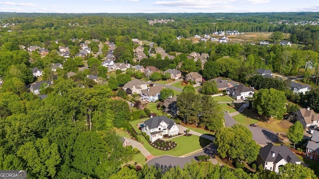 birds eye view of property featuring a view of trees and a residential view