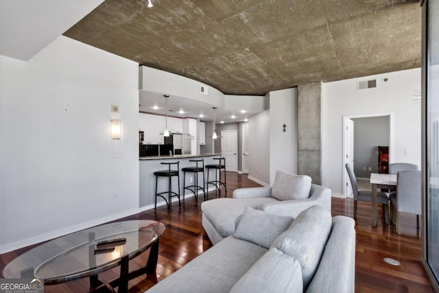 living room with baseboards, dark wood-type flooring, and visible vents