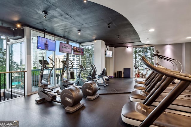 gym featuring recessed lighting and expansive windows