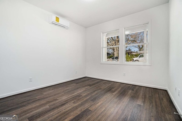 102 Dahlia Ave SW, Atlanta, GA 30314 - empty room with baseboards, a wall mounted AC, and dark wood finished floors