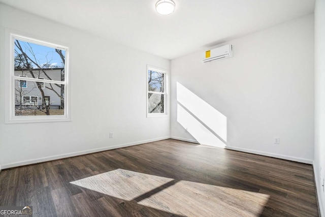 102 Dahlia Ave SW, Atlanta, GA 30314 - spare room featuring a wall mounted AC, wood finished floors, and baseboards
