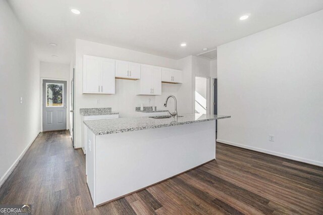102 Dahlia Ave SW, Atlanta, GA 30314 - kitchen with a kitchen island with sink, a sink, white cabinets, and dark wood-type flooring