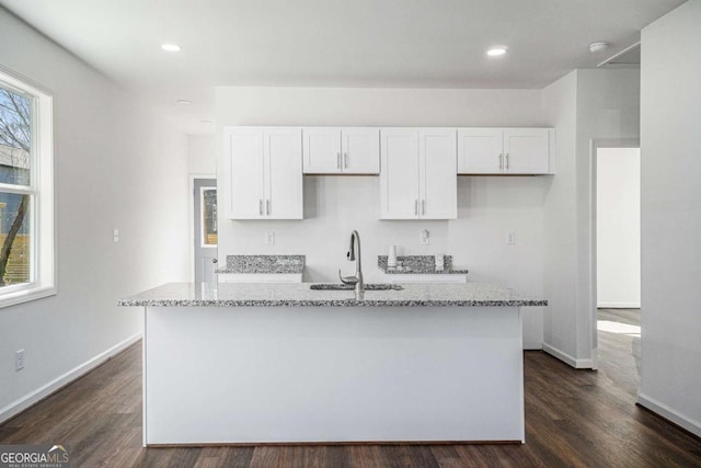 102 Dahlia Ave SW, Atlanta, GA 30314 - kitchen featuring white cabinets, an island with sink, dark wood-style flooring, and a sink