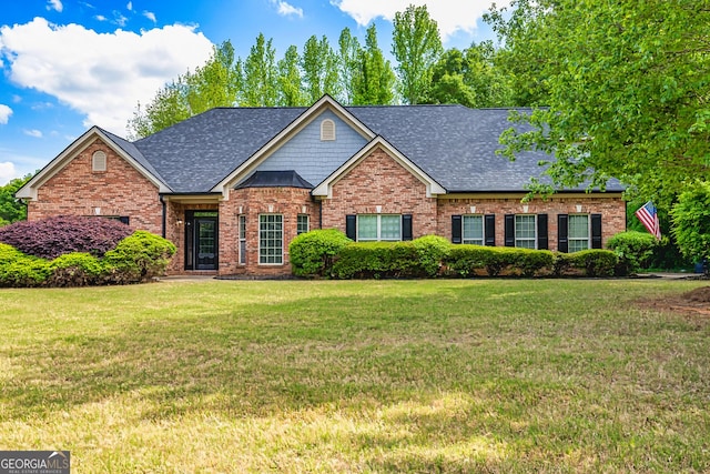 60 Fischer Trce, Newnan, GA 30265 - view of front of house with brick siding, a shingled roof, and a front lawn