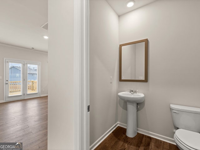 16 Virgil St, Dallas, GA 30132 - half bath with wood finished floors, toilet, a sink, crown molding, and baseboards
