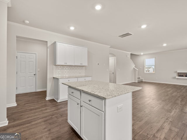 16 Virgil St, Dallas, GA 30132 - kitchen with a center island, dark wood-style flooring, crown molding, and visible vents