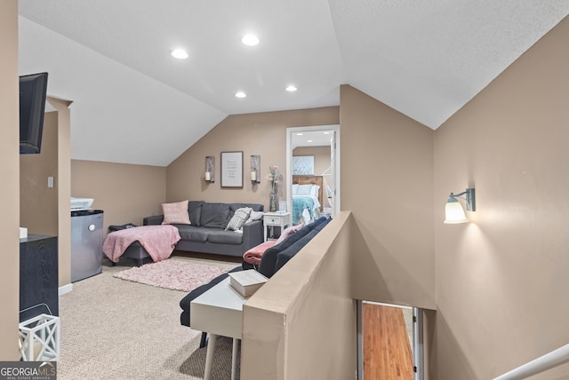 carpeted living area with lofted ceiling and recessed lighting