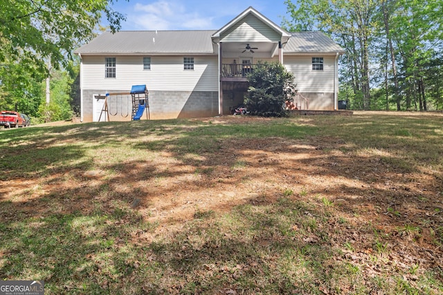 back of house featuring metal roof, a lawn, and ceiling fan