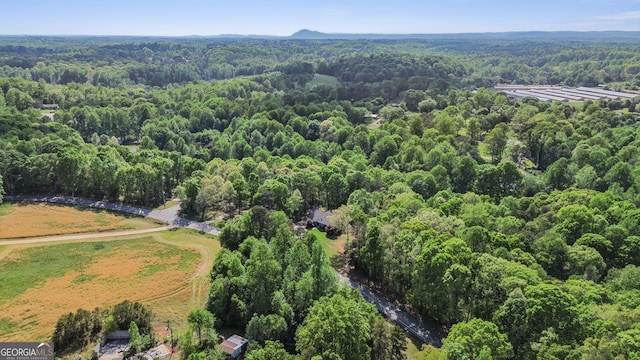 bird's eye view featuring a wooded view