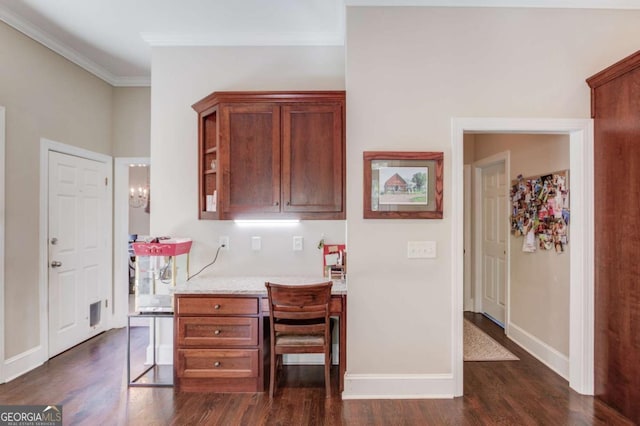 office space with baseboards, built in study area, dark wood-type flooring, and ornamental molding