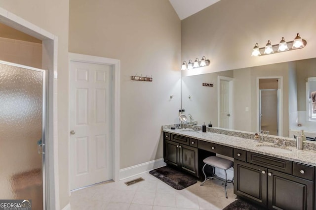 full bath featuring a shower stall, tile patterned floors, a sink, double vanity, and visible vents