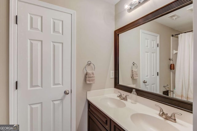 bathroom featuring double vanity and a sink