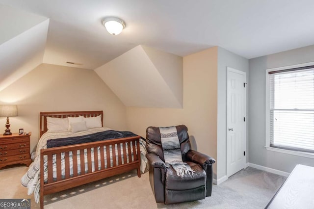 bedroom featuring vaulted ceiling, baseboards, and carpet floors