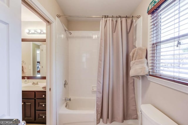 full bath featuring toilet, vanity, and shower / bathtub combination with curtain