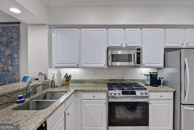 161 Limeburn Trl, Saint Simons, GA 31522 - kitchen with a sink, white cabinets, appliances with stainless steel finishes, light stone countertops, and recessed lighting