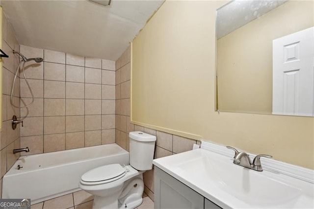 bathroom with vanity, tile walls, toilet, shower / bathtub combination, and tile patterned flooring