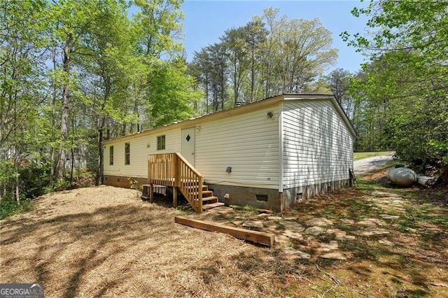 rear view of property with crawl space