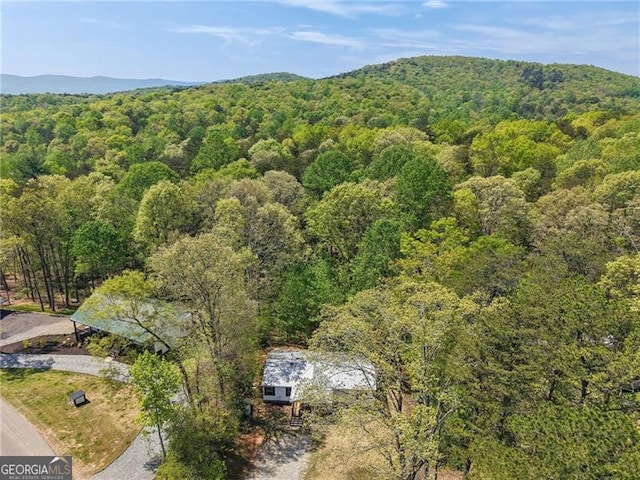drone / aerial view featuring a forest view