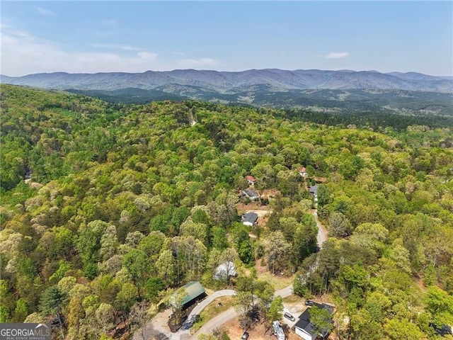 aerial view with a wooded view and a mountain view