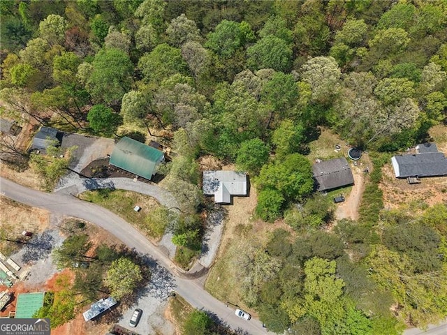 birds eye view of property with a wooded view