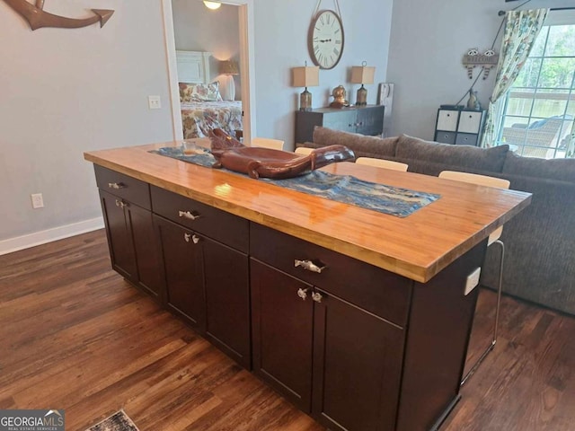 471 Getaway Ln, Baxley, GA 31513 - kitchen featuring wooden counters, dark wood-style flooring, a breakfast bar, and baseboards