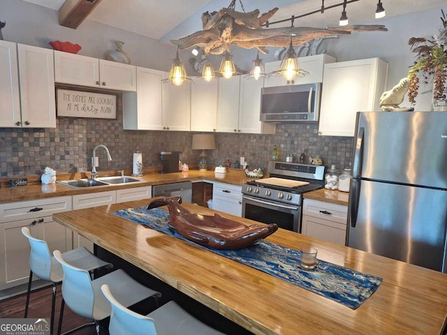 471 Getaway Ln, Baxley, GA 31513 - kitchen featuring butcher block countertops, stainless steel appliances, a sink, lofted ceiling, and tasteful backsplash